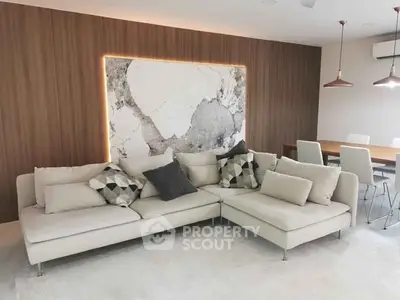 Modern living room with stylish sectional sofa and elegant dining area