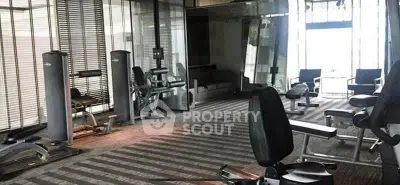 Spacious modern gym with state-of-the-art fitness equipment and large windows.