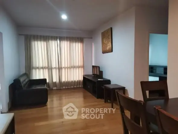 Spacious living room with wooden flooring and modern furniture