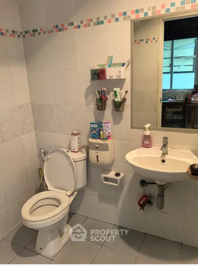 Cozy bathroom with modern fixtures and ample storage space.