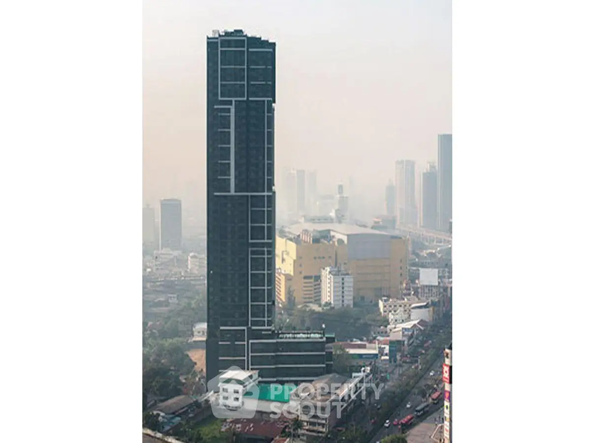 Stunning high-rise building with modern architecture in bustling cityscape.