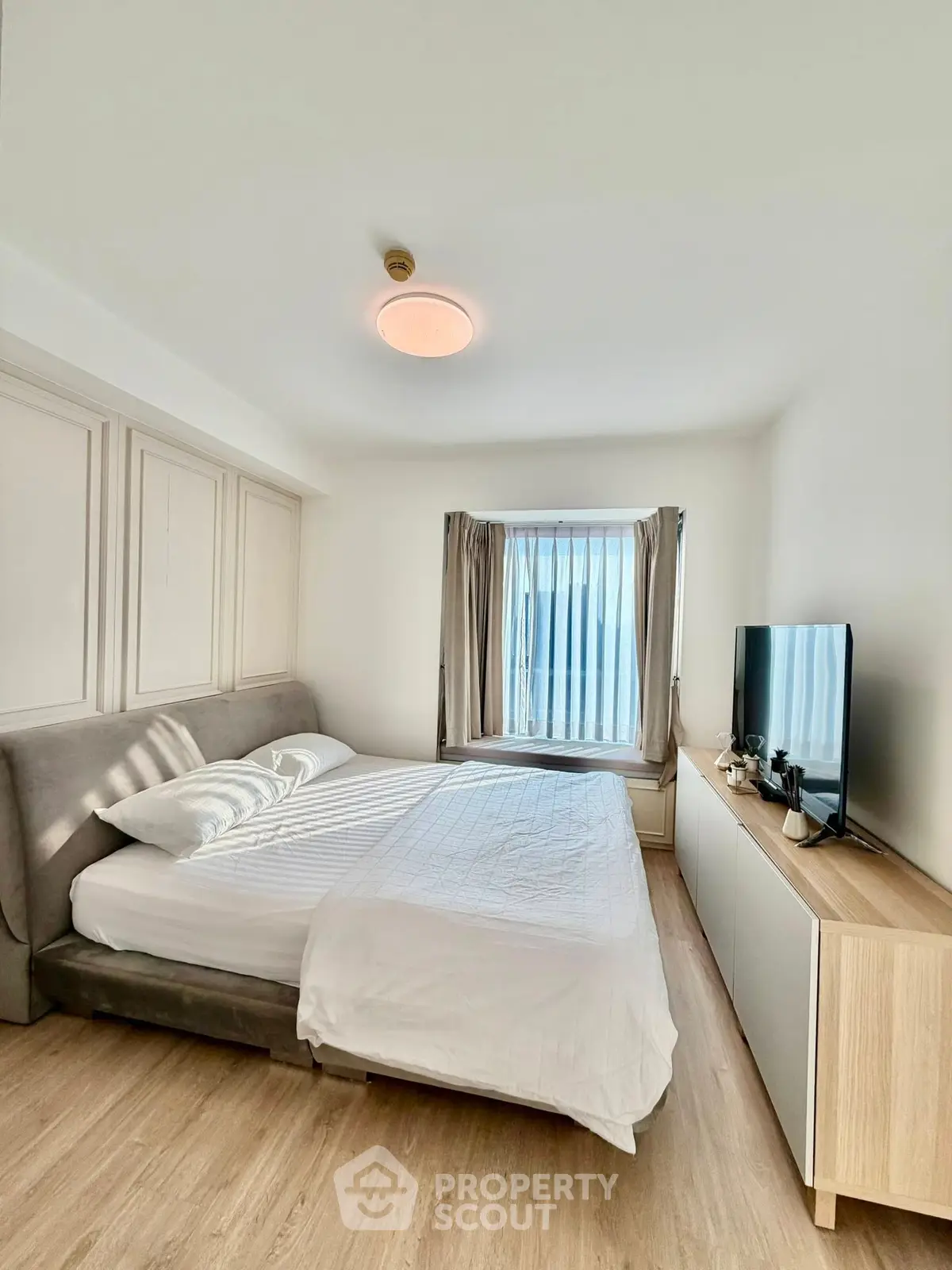 Bright and modern bedroom with sleek furnishings and natural light