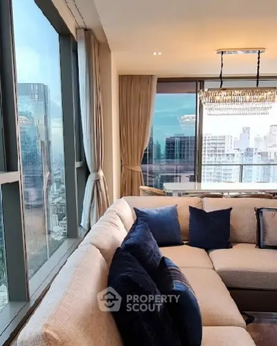 Luxurious living room with panoramic city view and elegant decor.