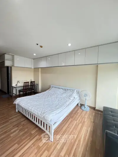 Spacious bedroom with modern furnishings and ample storage