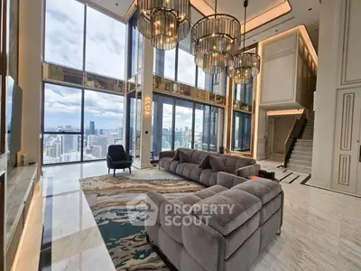 Luxurious high-rise living room with panoramic city views and elegant chandeliers.