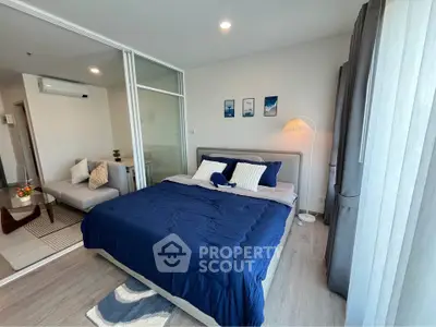 Modern bedroom with glass partition and cozy decor in a stylish apartment.