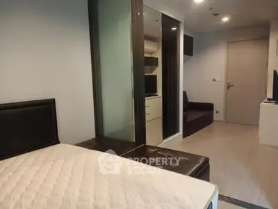 Modern studio apartment with sleek design and cozy furnishings, featuring a comfortable bed and stylish decor.