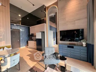 Luxurious modern living room with stylish furniture and open kitchen layout, featuring elegant decor and ample natural light.