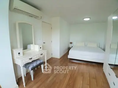 Spacious bedroom with elegant vanity and modern decor