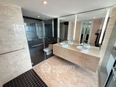 Luxurious modern bathroom with dual sinks and glass shower enclosure