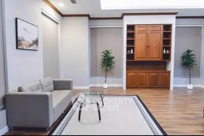 Elegant living room with modern decor and wooden cabinetry