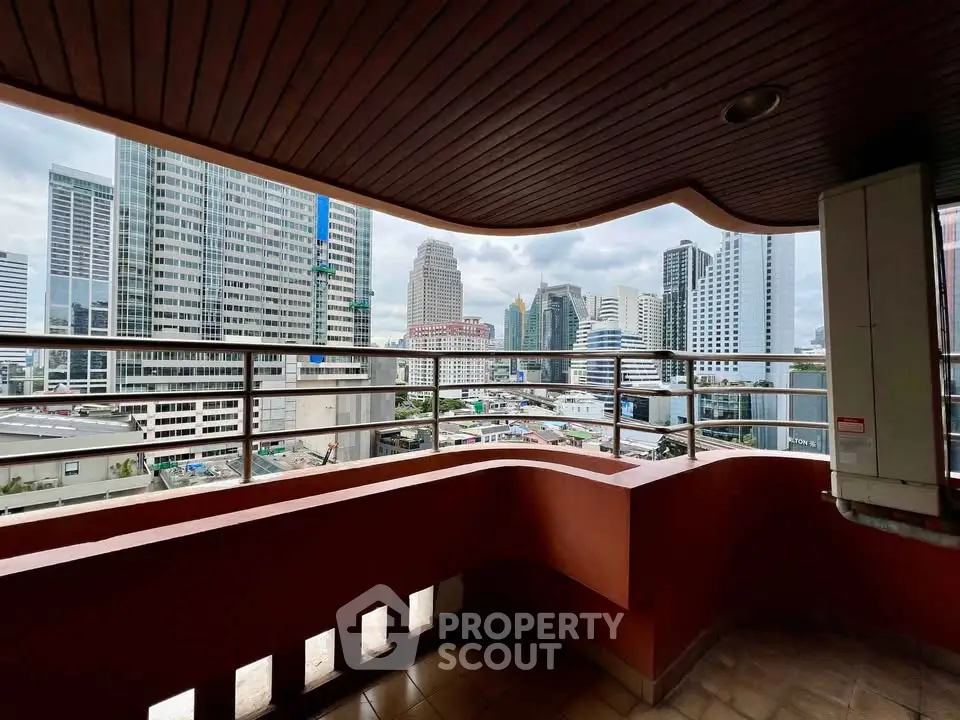 Stunning cityscape view from a spacious balcony in a high-rise building, perfect for urban living.