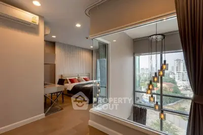 Modern bedroom with large window offering stunning city view