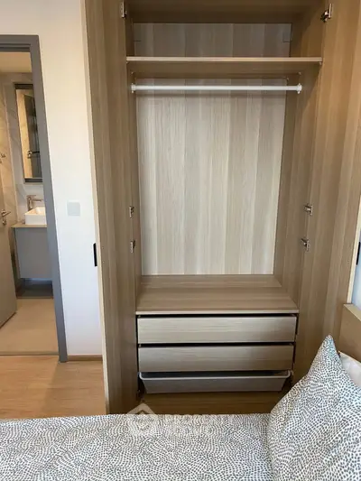 Modern bedroom with open wardrobe and view into bathroom