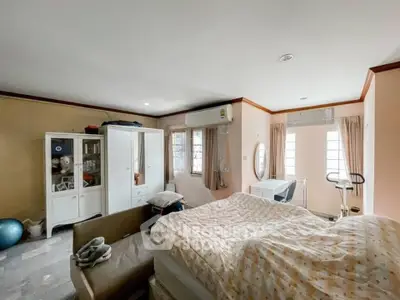 Spacious bedroom with modern furniture and exercise equipment