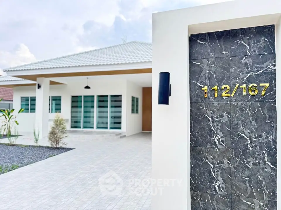 Modern single-story house with sleek exterior and stylish entrance