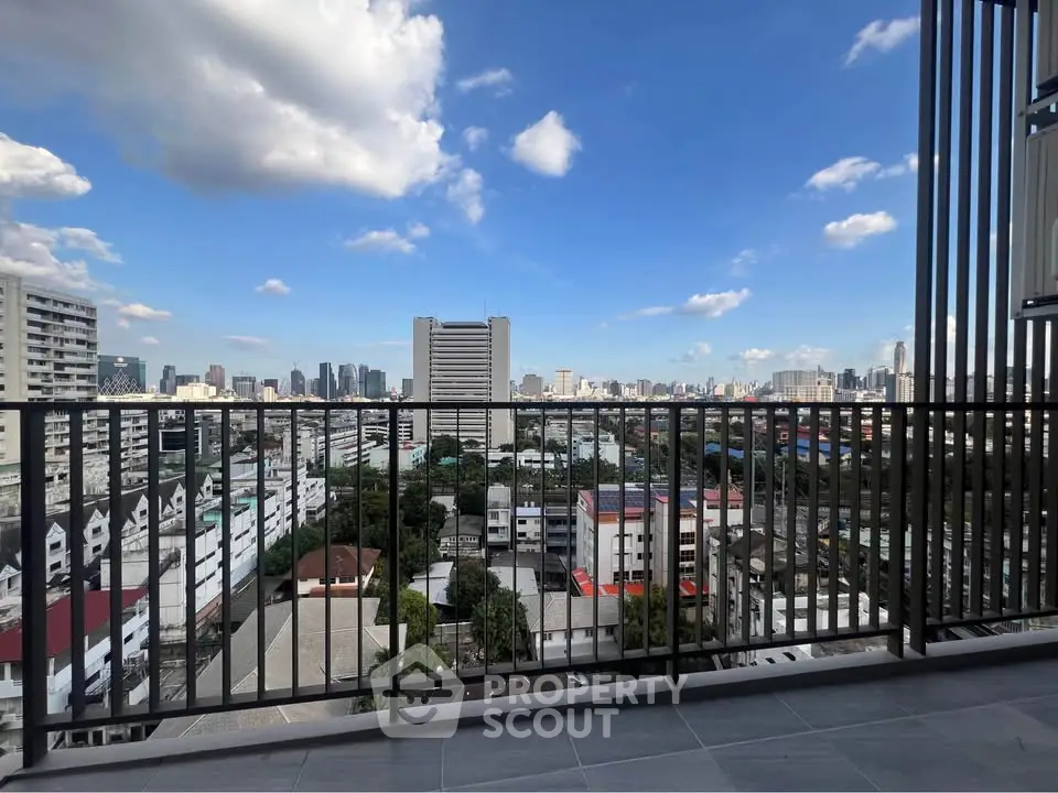 Stunning cityscape view from a modern balcony with sleek railing design.