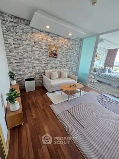 Stylish living room with modern decor and wooden flooring, featuring a cozy sofa and elegant coffee table.