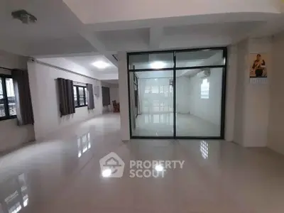 Spacious modern living area with glass partition and large windows