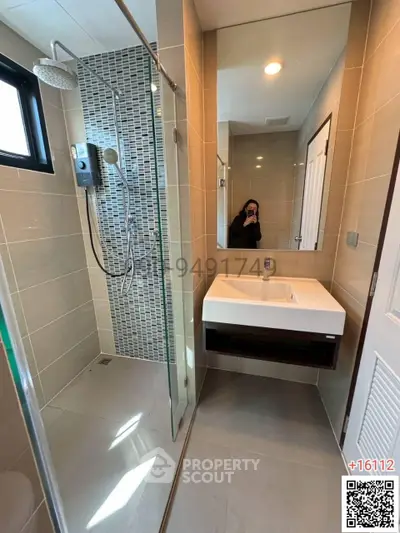 Modern bathroom with glass shower and sleek sink design