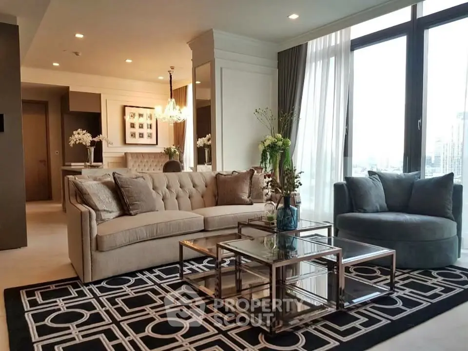 Luxurious living room with elegant decor and city view, featuring plush seating and modern glass coffee table.