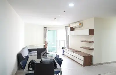 Spacious modern living room with balcony access and stylish furniture