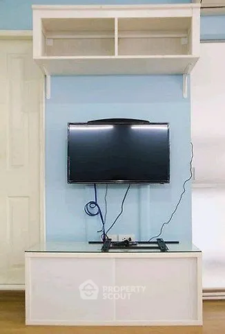 Modern living room with wall-mounted TV and sleek storage unit