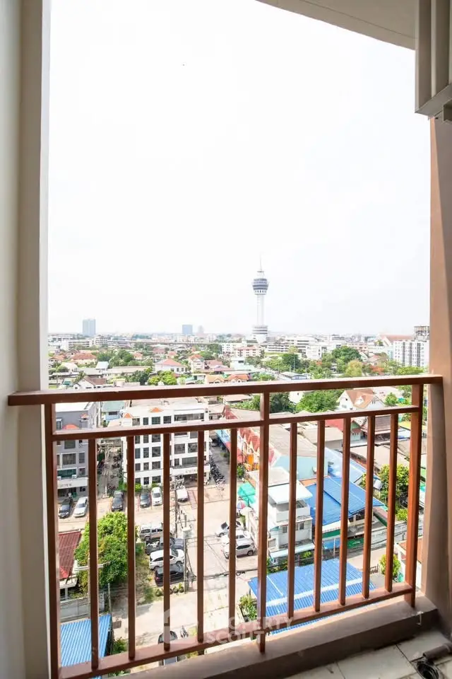 Stunning balcony view overlooking cityscape with iconic tower in the distance.