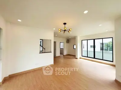 Spacious modern living room with large windows and elegant lighting