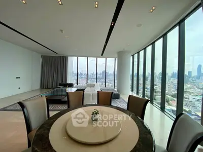 Luxurious corner unit living room with panoramic city views and elegant dining area.