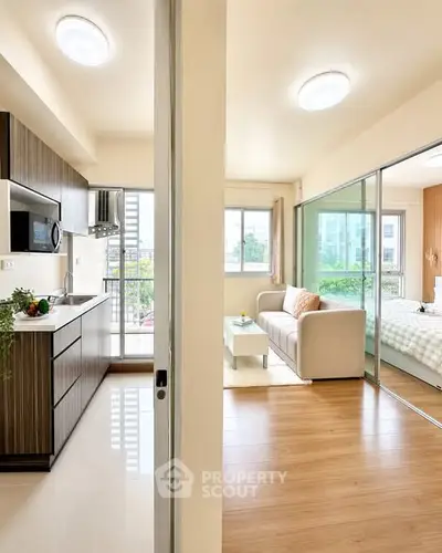 Modern apartment interior with open kitchen and cozy living room, featuring large windows and stylish decor.