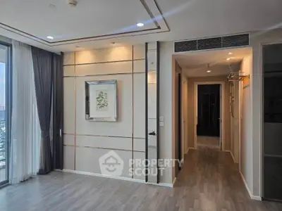 Modern living room with elegant decor and large windows offering city views.