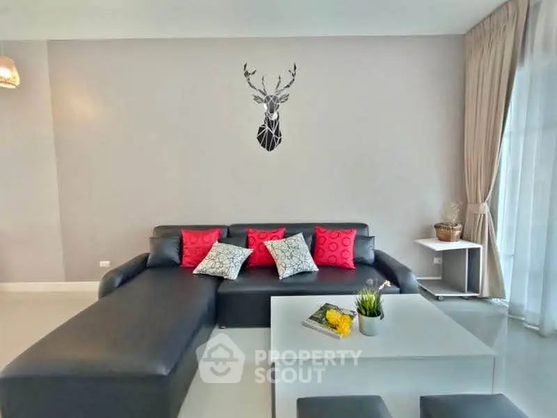 Modern living room with sleek black sofa and stylish decor