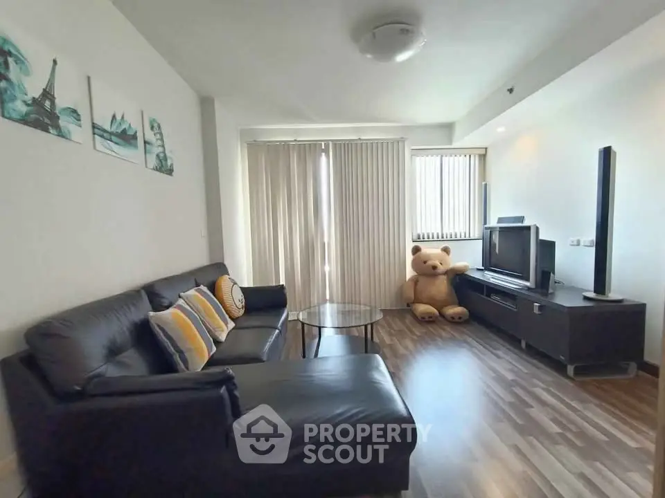 Spacious living room with modern decor and large teddy bear, perfect for relaxation.