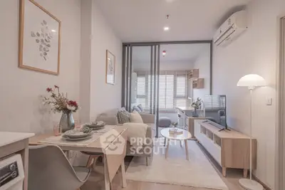 Modern living room with stylish decor and open layout, featuring cozy seating and natural light.