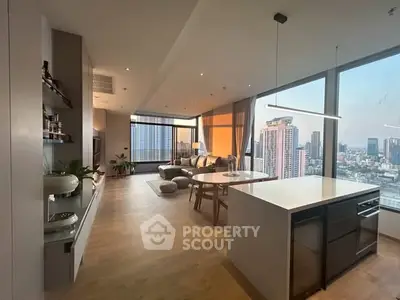 Luxurious open-plan living room with stunning city view and modern kitchen.