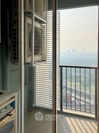High-rise balcony with city view and air conditioning unit, perfect for urban living.