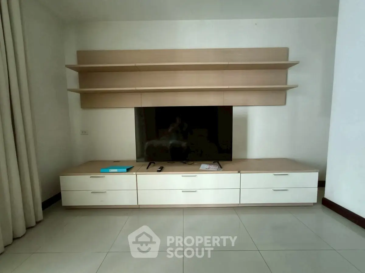 Modern living room with sleek TV unit and ample storage space
