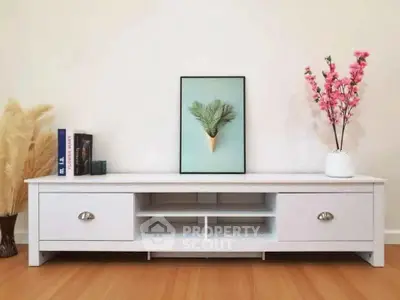 Stylish modern living room with elegant white TV stand and decorative accents.