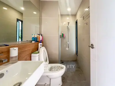 Modern bathroom with sleek fixtures and glass shower enclosure