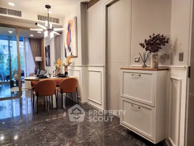 Elegant modern dining area with stylish decor and open layout, featuring marble flooring and contemporary lighting.