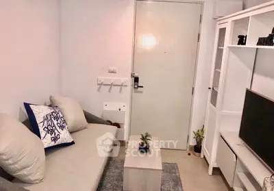 Cozy living room with modern decor and neutral tones, featuring a comfortable sofa and stylish TV unit.