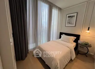 Cozy bedroom with elegant decor and large windows for natural light