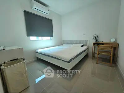 Modern bedroom with sleek design, featuring a comfortable bed, air conditioning, and stylish furniture.