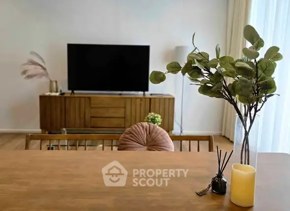 Modern living room with stylish decor and large TV, perfect for relaxation and entertainment.