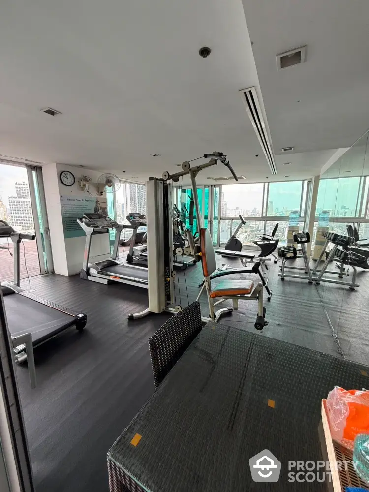 Modern gym with city view in high-rise building