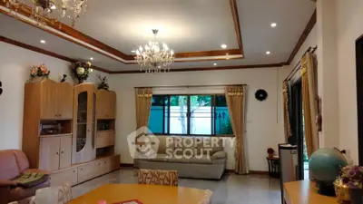 Elegant living room with chandeliers and cozy seating area