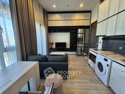 Modern living room with washing machine and sleek furniture in a stylish apartment.