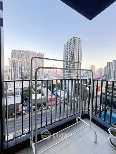 Spacious balcony with stunning city view in modern high-rise apartment.