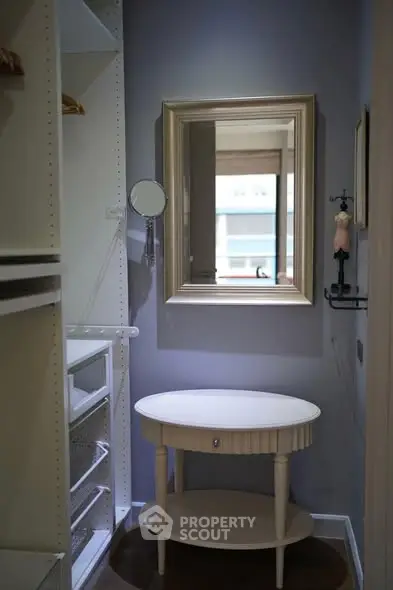 Chic walk-in closet with elegant mirror and stylish table